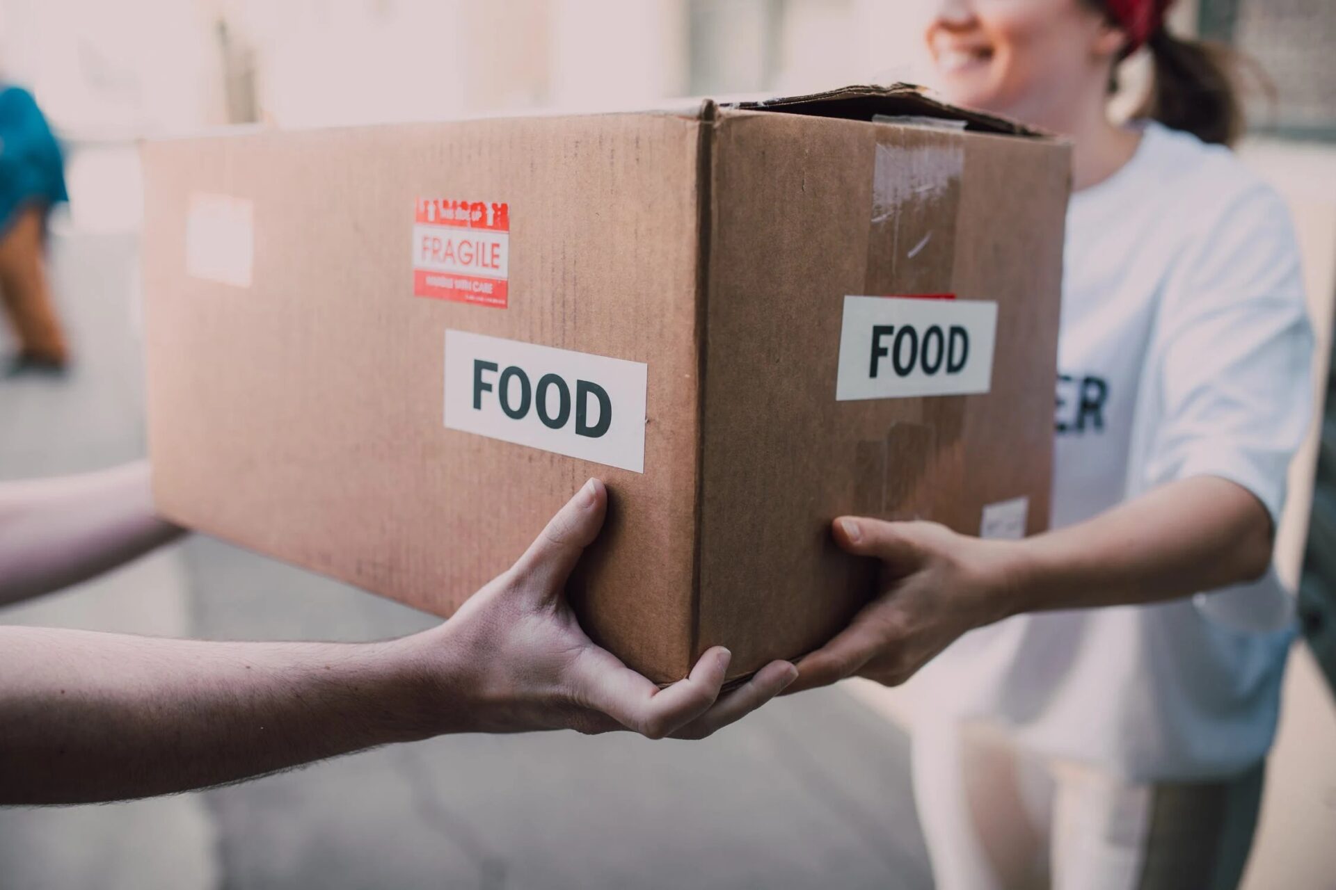 Girl carrying a box with food